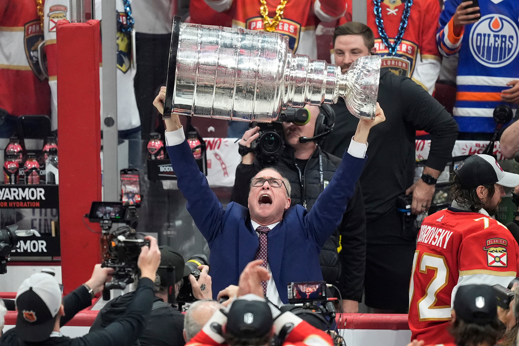 FILE - Florida Panthers head coach Paul Maurice lifts the Stanley Cup trophy after Game 7 of the NHL hockey Stanley Cup Final against the Edmonton Oilers, Monday, June 24, 2024, in Sunrise, Fla. The Panthers defeated the Oilers 2-1 (AP Photo/Rebecca Blackwell, file)