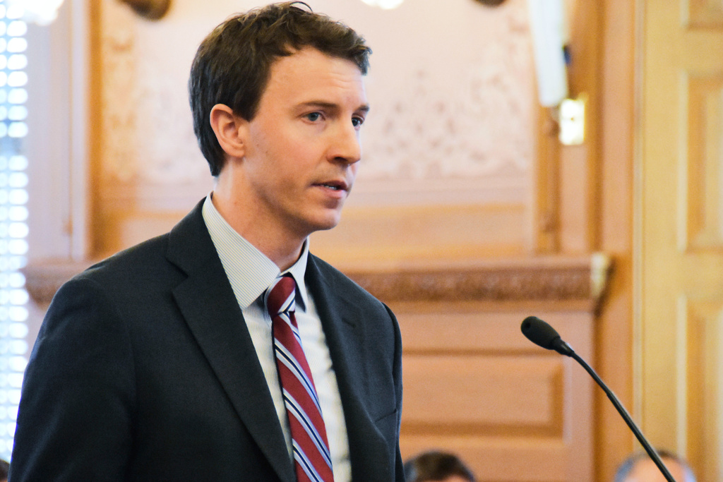 FILE - Bryan Seeley, a Major League Baseball senior vice president, testifies on a bill during a legislative committee hearing, March 13, 2018, at the Statehouse in Topeka, Kan. (AP Photo/Mitchell Willetts, File)