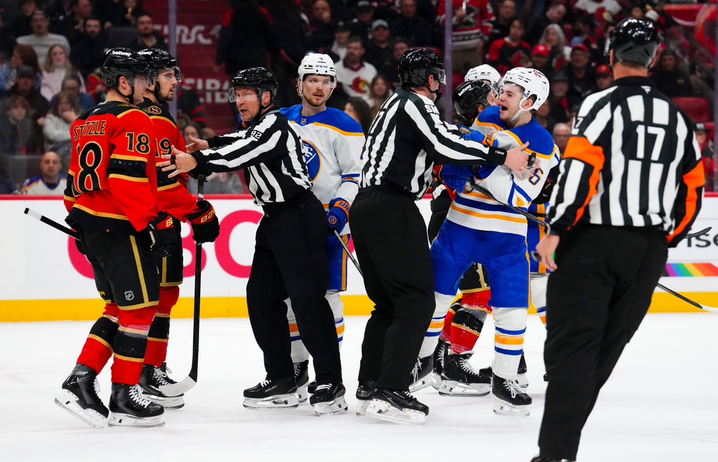 Buffalo Sabres' Zach Benson (6) yells at Ottawa Senators' Tim Stutzle (18) at the end of the first period of NHL hockey game action in Ottawa, Ontario, Thursday, April 2, 2026. (Sean Kilpatrick/The Canadian Press via AP)