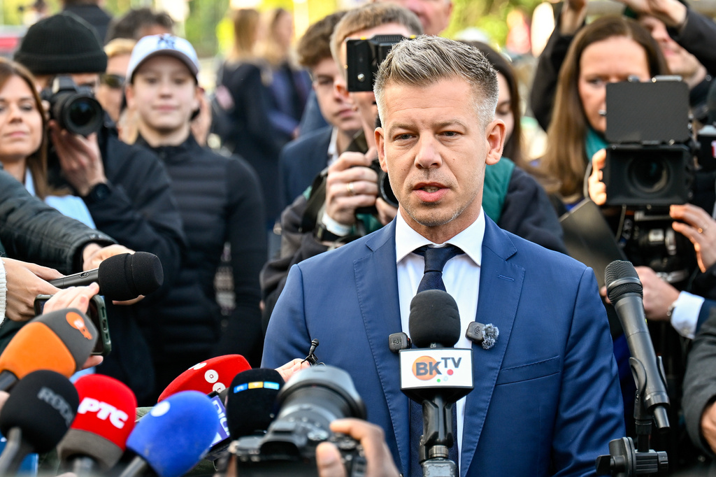 Peter Magyar, leader of the opposition Tisza party, speaks to the media outside a polling station in Budapest, Hungary, Sunday, April 12, 2026. (AP Photo/Denes Erdos)