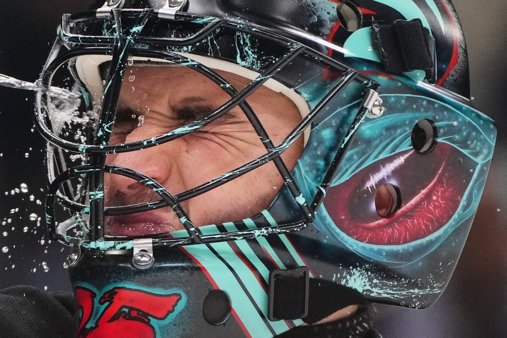 Seattle Kraken goaltender Joey Daccord sprays water on his face after allowing a goal by San Jose Sharks defenseman John Klingberg during the second period of an NHL hockey game Wednesday, Nov. 5, 2025, in Seattle. (AP Photo/Lindsey Wasson)