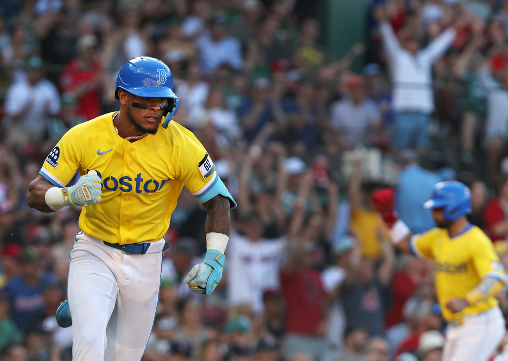 Boston Red Sox's Ceddanne Rafaela pumps his fist as he heads for first base with a seventh-inning two-run single during a baseball game against the Texas Rangers, Saturday, June 13, 2026,,,,,,, in Boston. (AP Photo/Jim Davis)