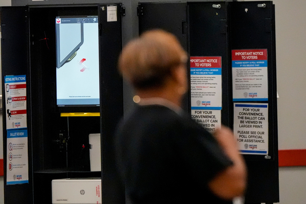 A voting machine is seen as people vote in a runoff election at the C.T. Martin Recreation Center, Tuesday, June 16, 2026, in Atlanta. (AP Photo/Mike Stewart)