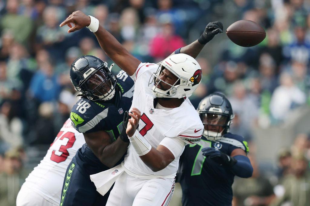 Seattle Seahawks linebacker Tyrice Knight (48) causes a fumble by Arizona Cardinals quarterback Jacoby Brissett, right, during the first half of an NFL football game Sunday, Nov. 9, 2025, in Seattle. (AP Photo/Maddy Grassy)