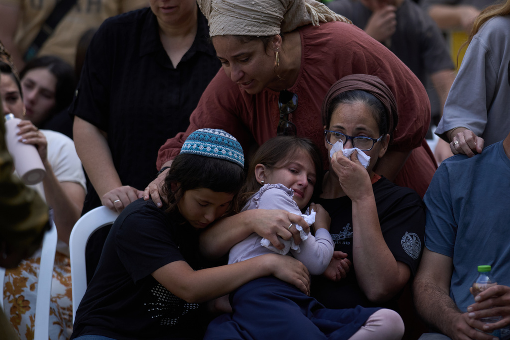 Relatives mourn during the funeral of the Israeli-American reservist Master Sergeant Yona Efraim Feldbaum, who was killed in the Gaza Strip, at Mount Herzl military cemetery, in Jersualem, Wednesday, Oct. 29, 2025. (AP Photo/Leo Correa)