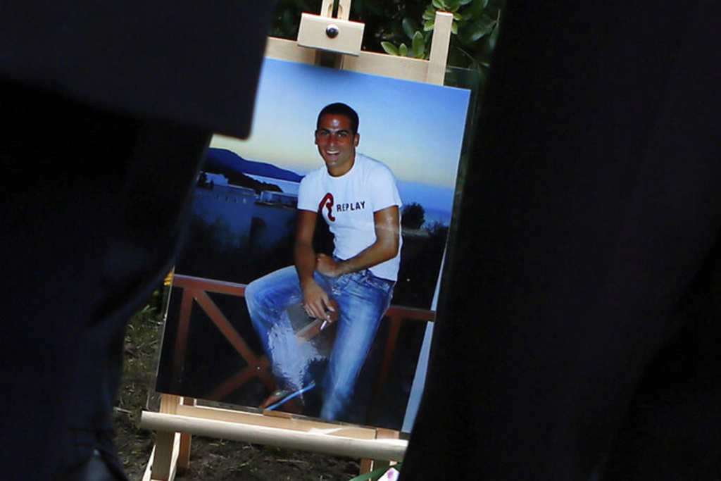 FILE - A picture of Ilan Halimi is seen at a makeshift memorial, in Sainte Genevieve des Bois, south suburb of Paris, Wednesday, Feb. 13, 2019 during a tribute ceremony (AP Photo/Francois Mori, File)