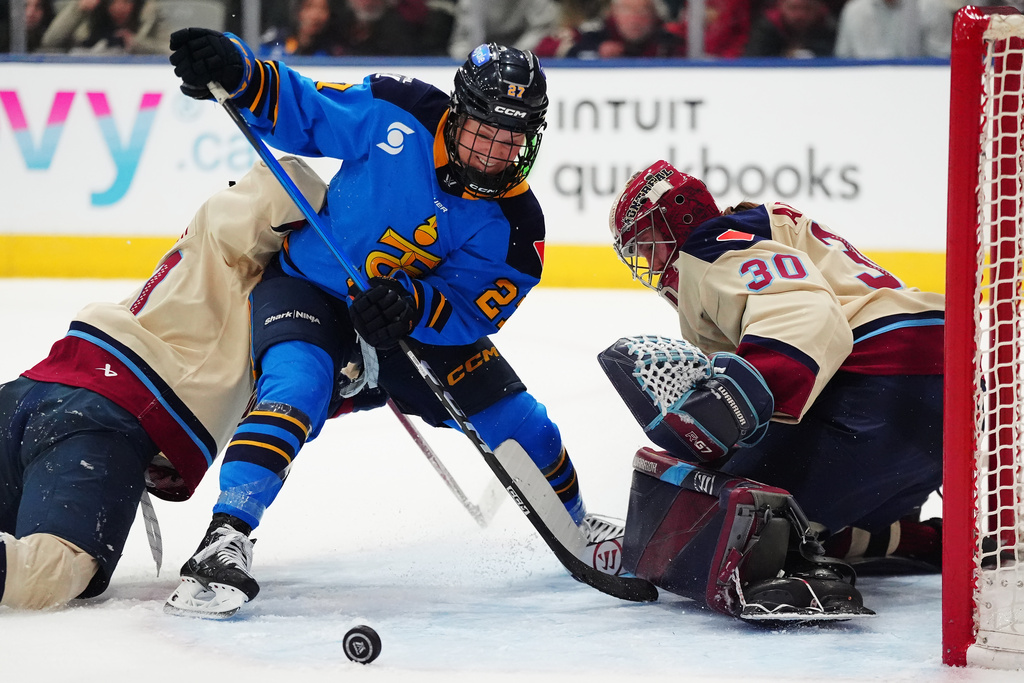 Montreal Victoire goaltender Sandra Abstreiter (30) stops Toronto Sceptres' Emma Maltais (27) during an overtime of a PWHL hockey game in Toronto on Tuesday, March 3, 2026. (Frank Gunn/The Canadian Press via AP)