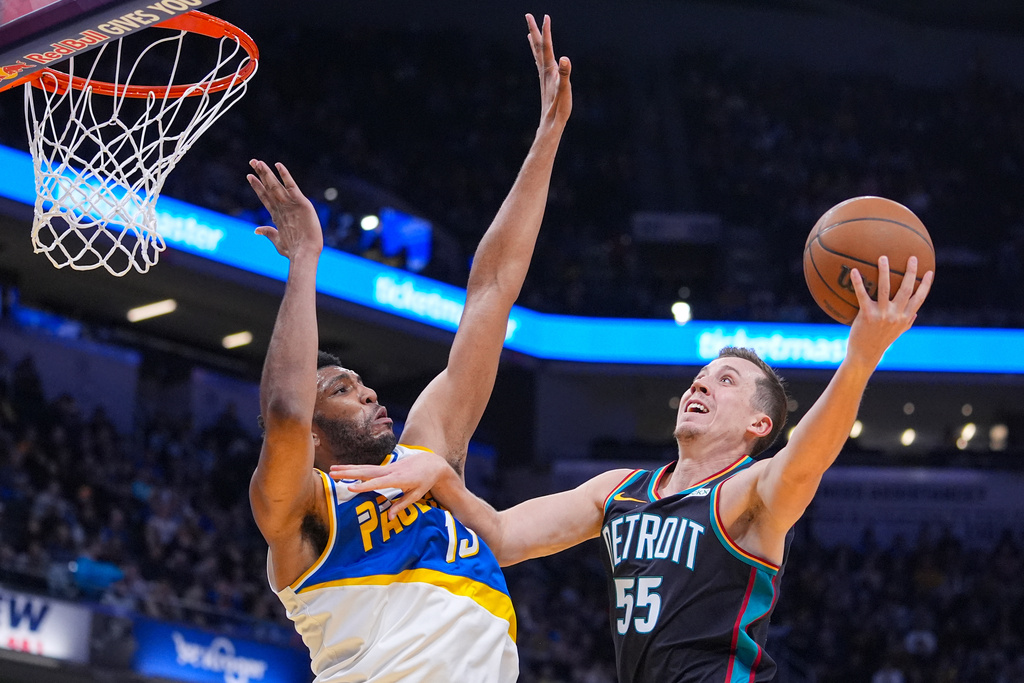 Detroit Pistons forward Duncan Robinson (55) shoots over Indiana Pacers center Tony Bradley (13) during the first half of an NBA basketball game in Indianapolis, Monday, Nov. 24, 2025. (AP Photo/Michael Conroy)