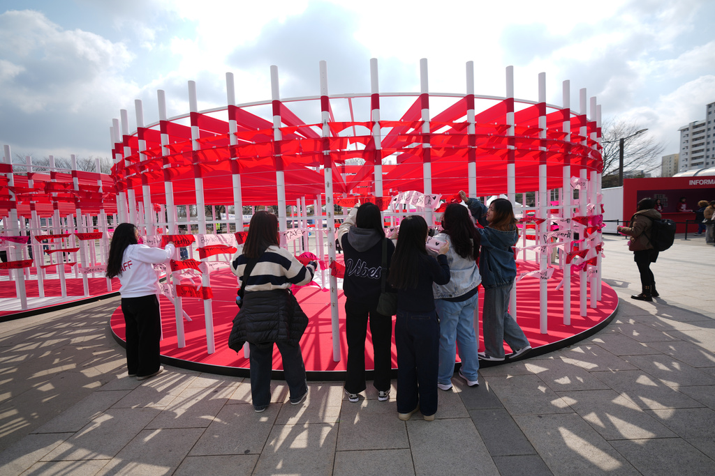 Fans of K-pop band BTS hang banners for BTS on the wall at a fan zone promoting the news album of BTS near the Han River in Seoul, South Korea, Friday, March 20, 2026. (AP Photo/Lee Jin-man)