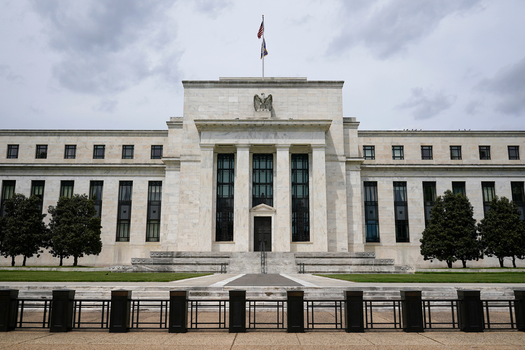 FILE - An U.S. flag flies over the Federal Reserve building on May 4, 2021, in Washington. (AP Photo/Patrick Semansky, File)