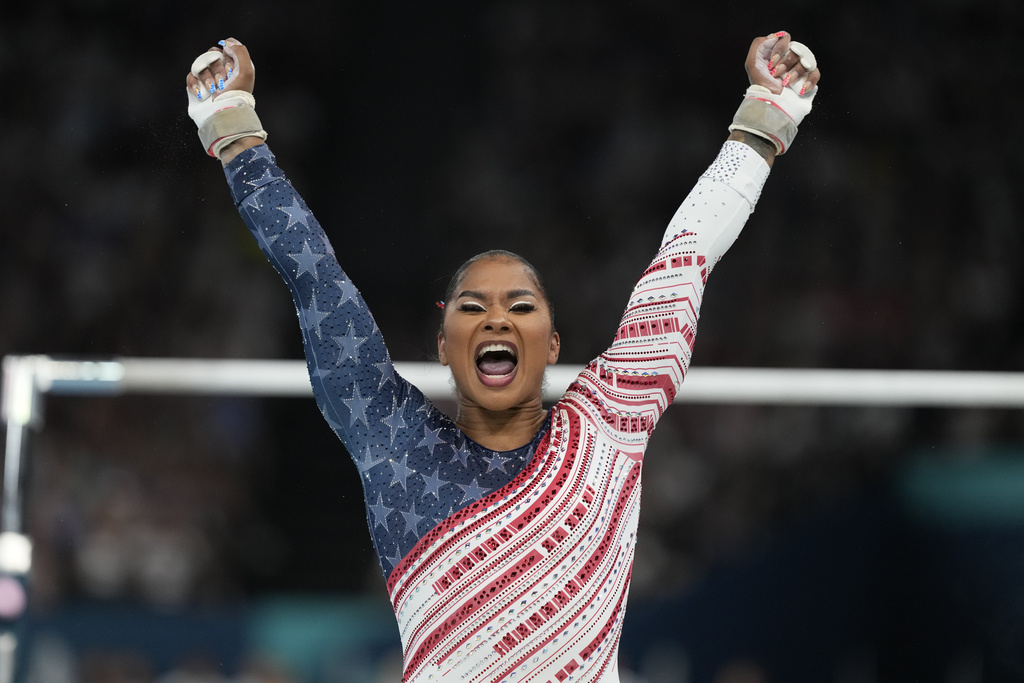 Jordan Chiles, of the United States, celebrates after performing on the uneven bars during the women's artistic gymnastics team finals round at Bercy Arena at the 2024 Summer Olympics, Tuesday, July 30, 2024, in Paris, France. (AP Photo/Natacha Pisarenko)