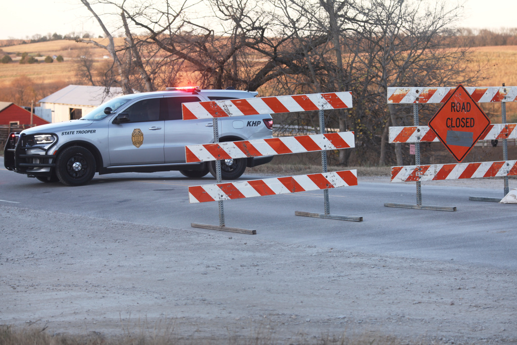 A Kansas Highway Patrol vehicle sits at a roadblock near the scene of a shooting, which resulted in multiple casualties, Saturday, Nov. 15, 2025, in Carbondale, Kansas. (AP Photo/John Hanna)