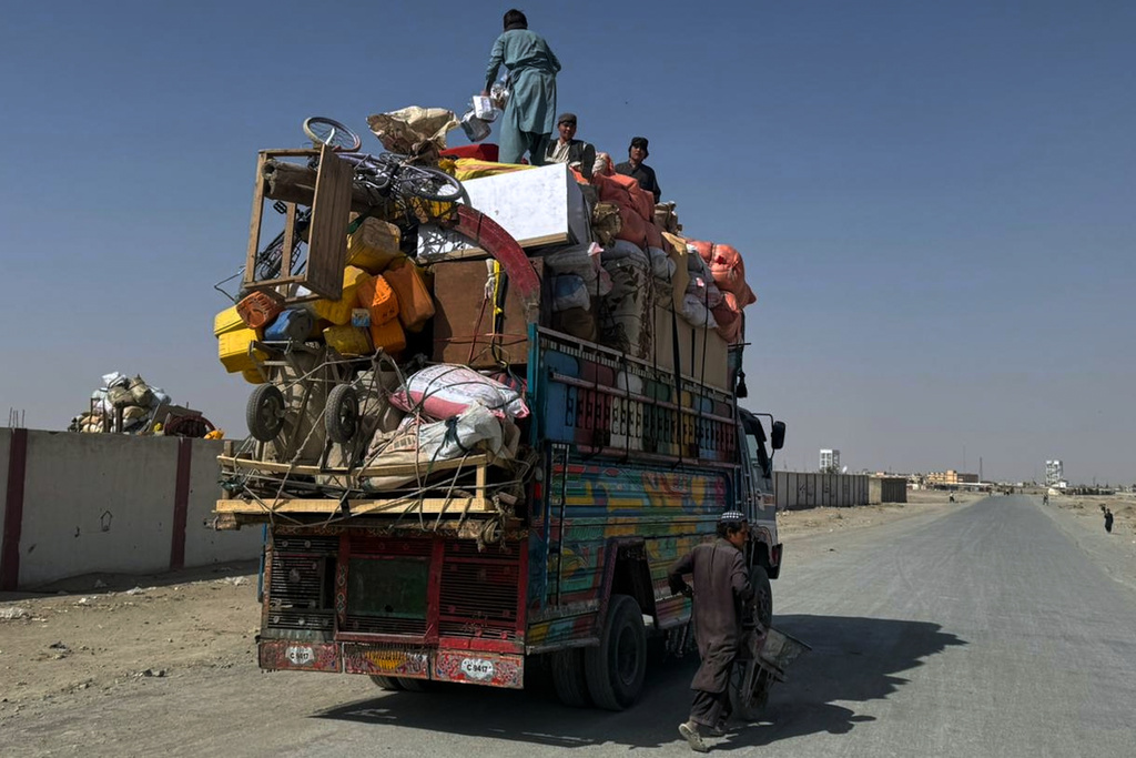 Afghan refugees prepare to leave for their homeland through a border crossing point which partially opens following Pakistan Afghanistan ceasefire truce, at a camp in Chaman, a border town on the Pakistan Afghan border, Sunday, Oct. 19, 2025. (AP Photo/H. Achakzai)