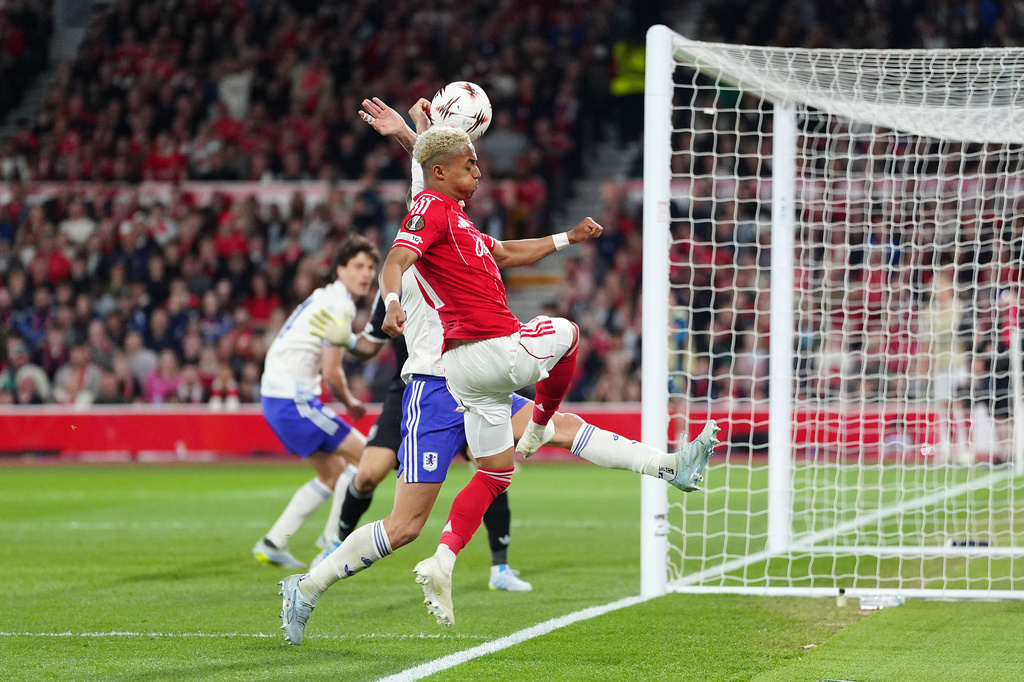 Aston Villa's Lucas Digne, covered, handles the ball in the penalty area resulting in a penalty to Nottingham Forest during the Europa League semifinal first leg soccer match between Nottingham Forest and Aston Villa in Nottingham, England, Thursday, April 30, 2026. (David Davies/PA via AP)