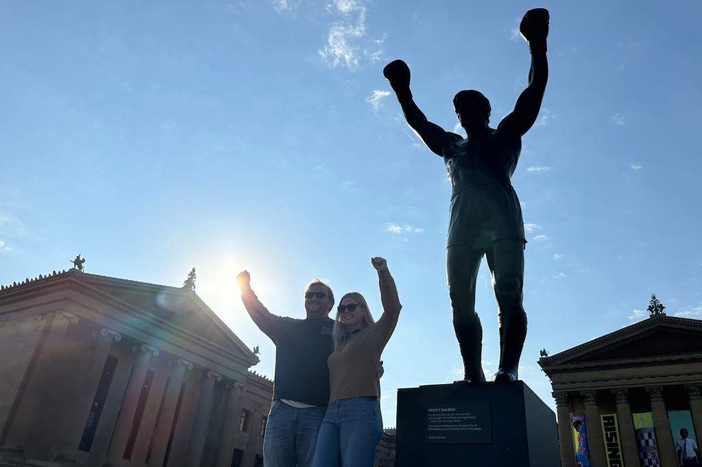 Visitors pose in front of the Rocky statue at the Philadelphia Museum of Art in Philadelphia, on Wednesday, April 22, 2026 (AP Photo/Tassanee Vejpongsa)