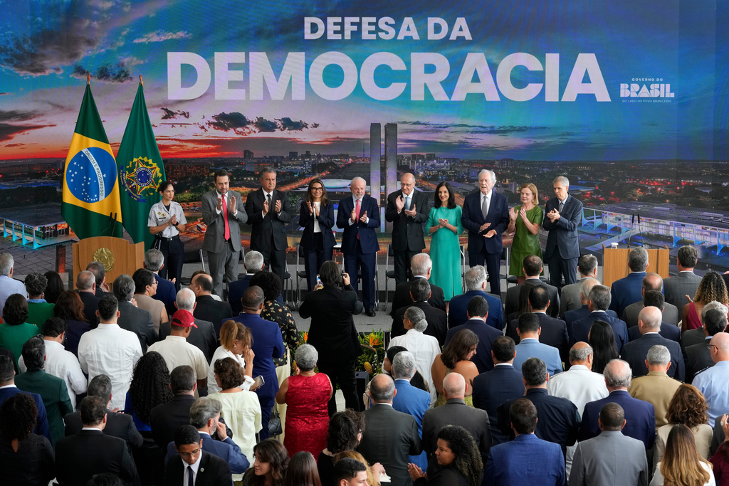Brazilian President Luiz Inacio Lula da Silva, center, and his wife, first lady Rosangela da Silva, attend a ceremony marking the three year anniversary of a failed attempt to overthrow Brazil’s democratic system, at Planalto presidential palace in Brasilia, Brazil, Thursday, Jan. 8, 2026. (AP Photo/Eraldo Peres)