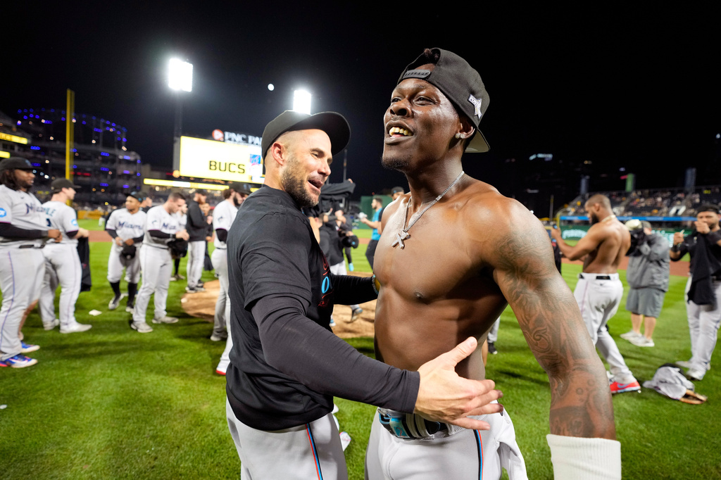 FILE - Miami Marlins' Jazz Chisholm Jr., right, celebrates with manager Skip Schumaker after clinching a playoff berth with a win over the Pittsburgh Pirates in a baseball game in Pittsburgh, Sept. 30, 2023. (AP Photo/Gene J. Puskar, File)