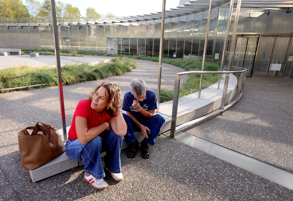 Christy Lock and Curt Rohrman, from Houston get a phone call informing them their tickets for a tram ride to the top of Gateway Arch are cancelled due to the federal government shutdown and that they will be receiving a refund on Wednesday, Oct. 1, 2025 in St. Louis. (David Carson/St. Louis Post-Dispatch via AP)