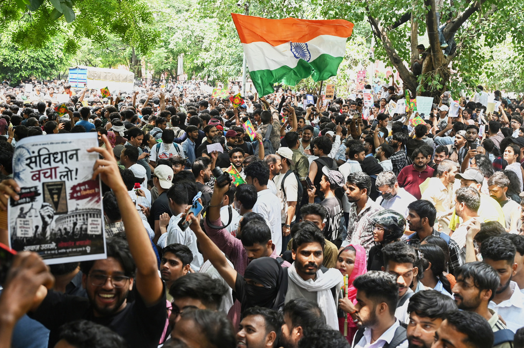 A protestor carries a poster with a message in Hindi which translates as 'Save Our Constitution' as he participates in a protest movement led by Cockroach Janta Party, in New Delhi, India, Wednesday, July 22, 2026. (AP Photo/Vipin)