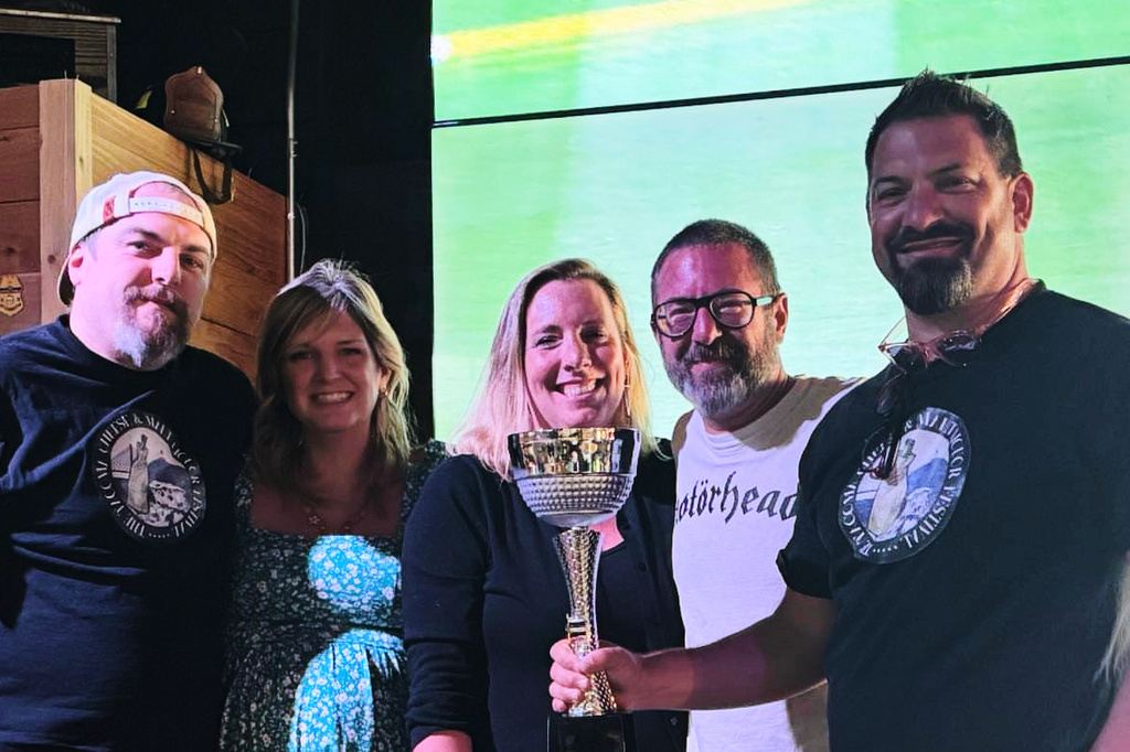 This photo provided by Kole Musgrove shows John Forsberg, far right, holding a trivia championship trophy and poses for a photo with other members of his team at Ashtown Brewing Company in Longview, Wash, on July 1, 2025. (Kole Musgrove via AP)