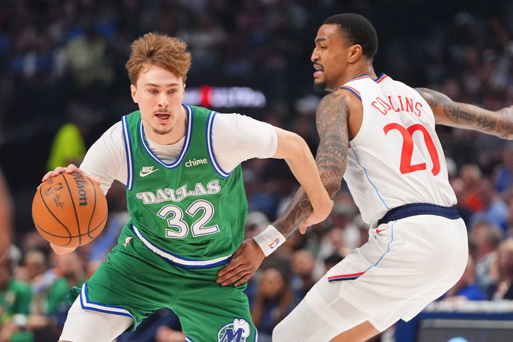 Dallas Mavericks forward Cooper Flagg (32) drives against Los Angeles Clippers forward John Collins (20) during the first half of an NBA basketball game in Dallas, Saturday, March 21, 2026. (AP Photo/LM Otero)