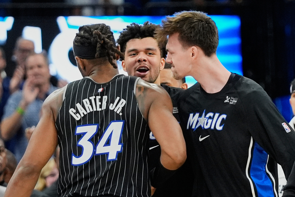 Orlando Magic center Wendell Carter Jr. (34) celebrates with Noah Penda, center, and Colin Castleton after making the game winning shot against the Dallas Mavericks with 1.4 seconds left in an NBA basketball game, Thursday, March 5, 2026, in Orlando, Fla. (AP Photo/John Raoux)
