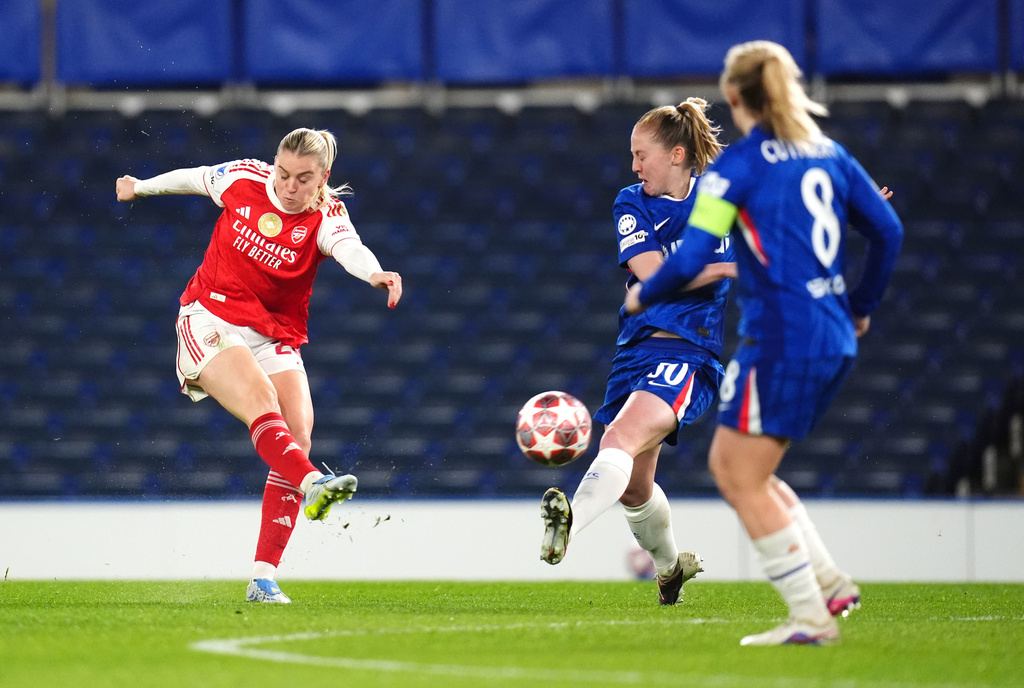 Arsenal's Alessia Russo, left, shoots the ball during the Women's Champions League quarterfinal second leg soccer match between Chelsea and Arsenal in London, Wednesday, April 1, 2026. (John Walton/PA via AP)