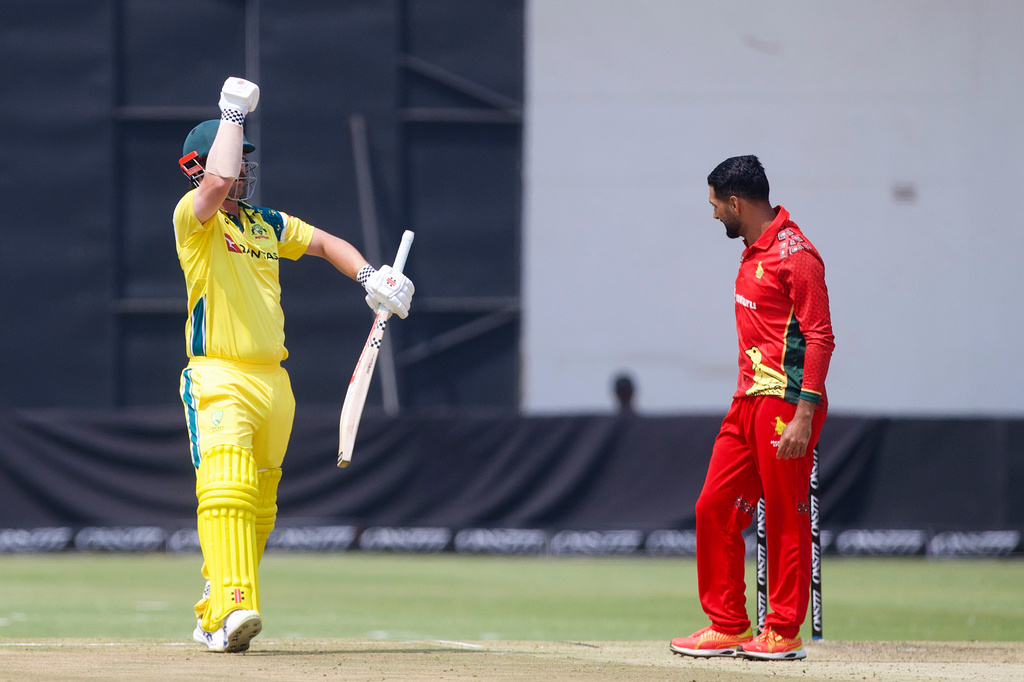 Australia's batsman Travis Head, left, celebrates his half century next to Zimbabwe's captain Sikandar Butt during the second-one day international cricket match between Zimbabwe and Australia in Harare, Zimbabwe, Friday, Sept.18, 2026. (AP Photo/Wonder Mashura)