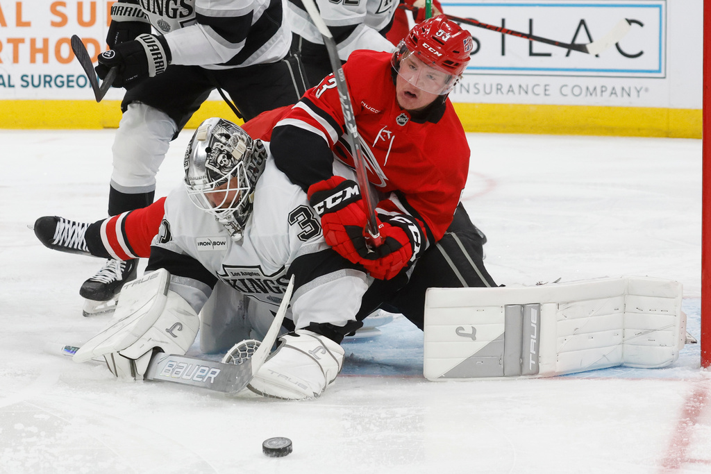Carolina Hurricanes' Jackson Blake (53) gets tied up with Los Angeles Kings goaltender Anton Forsberg, left, during the second period of an NHL hockey game in Raleigh, N.C., Sunday, Feb. 1, 2026. (AP Photo/Karl DeBlaker)