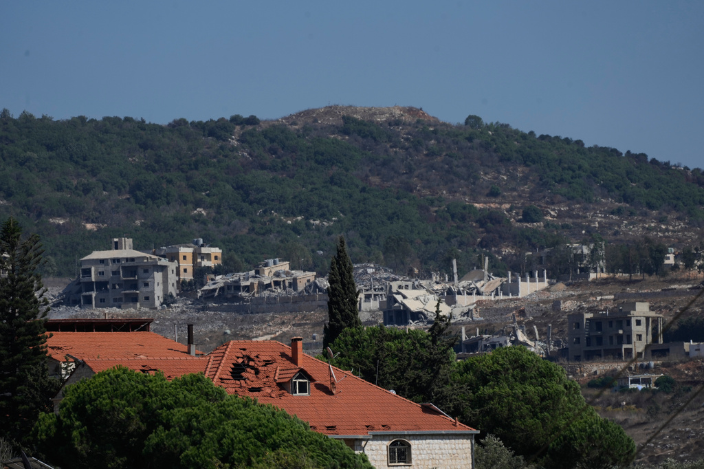 The Ali Taher Hill is seen in the background overlooking destroyed houses in the southern village of Kfar Rumman, Lebanon, Friday, Sept. 4, 2026. (AP Photo/Mohammed Zaatari)