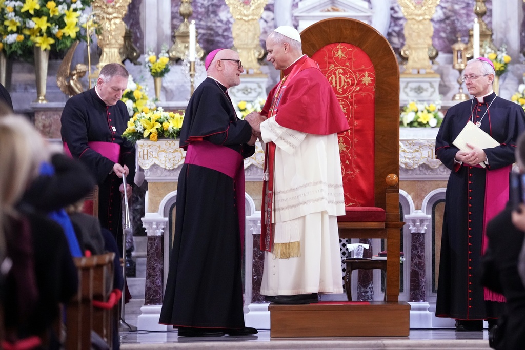 Pope Leo XIV talks with Archbishop Martin Kmetec of Izmir during a meeting with the clergy at the Cathedral of the Holy Spirit, in Istanbul, Turkey, Friday, Nov. 28, 2025. (AP Photo/Domenico Stinellis)