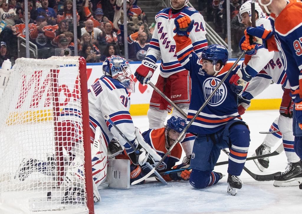 Edmonton Oilers' Matt Savoie, center right, celebrates after a goal against New York Rangers goalie Igor Shesterkin (31) during second-period NHL hockey game action in Edmonton, Alberta, Thursday, Oct. 30, 2025. (Jason Franson/The Canadian Press via AP)