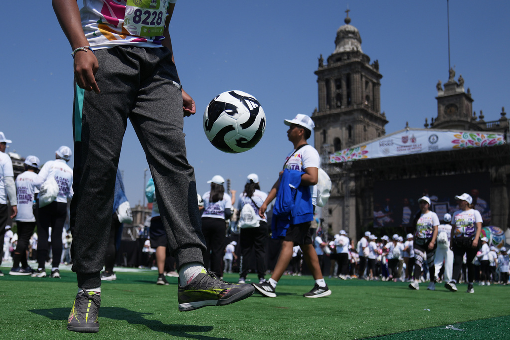 People practice soccer skills in an attempt to set a Guinness World Record for the "largest soccer class" at the Zocalo in Mexico City, Sunday, March 15, 2026. (AP Photo/Marco Ugarte)
