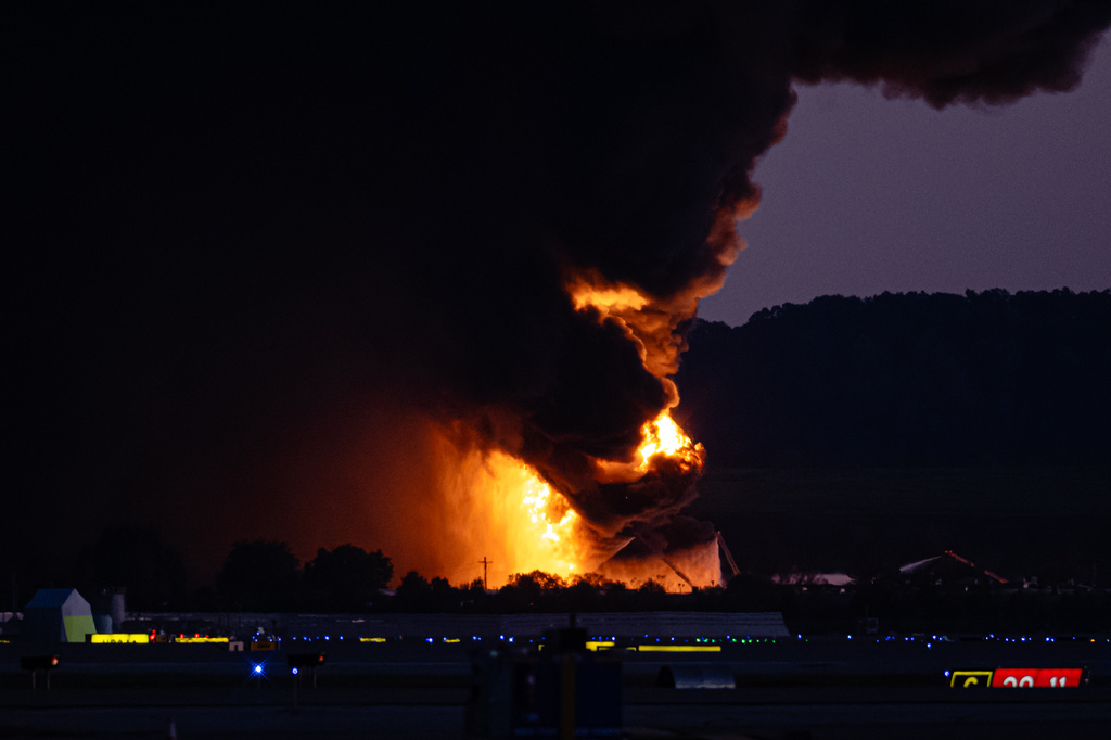 A fireball erupts near airport property after reports of a plane crash at Louisville International Airport, Tuesday, Nov. 4, 2025, in Louisville, Ky. (AP Photo/Jon Cherry)