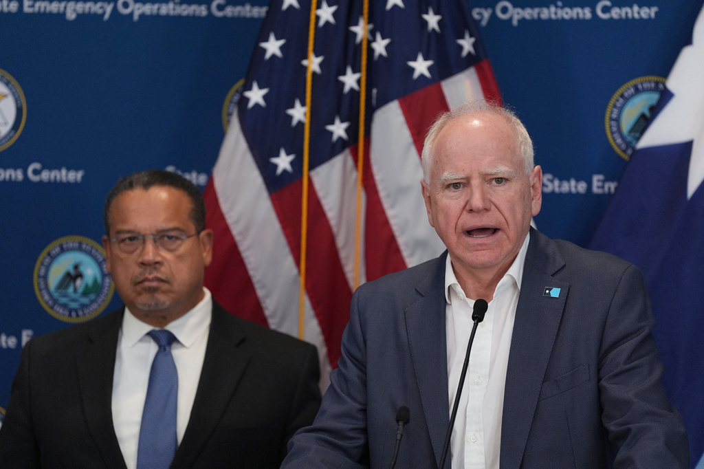 CORRECTS PRETTY TO PRETTI - Minnesota Gov. Tim Walz, right, and Attorney General Keith Ellison discuss the shooting of Alex Pretti during a news conference in Blaine, Minn., Sunday, Jan. 25, 2026. (AP Photo/Abbie Parr)