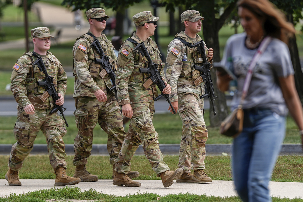 Armed National Guardsmen patrol along the National Mall, Tuesday, Aug. 26, 2025, in Washington. (AP Photo/Julia Demaree Nikhinson)