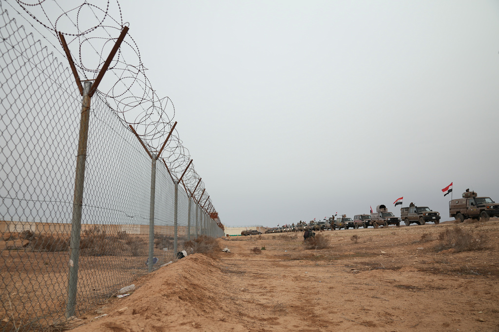 Iraqi Border Guards patrol in armored vehicles along the border with Syria, in Sinjar, northern Iraq, Thursday, Jan. 22, 2026. (AP Photo/Farid Abdulwahed)