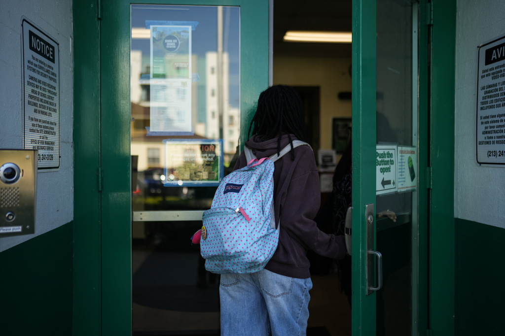 Makeda Walker-Deen, a junior at Susan Miller Dorsey Senior High School, enters the school in Los Angeles, Thursday, May 14, 2026. (AP Photo/Jae C. Hong)