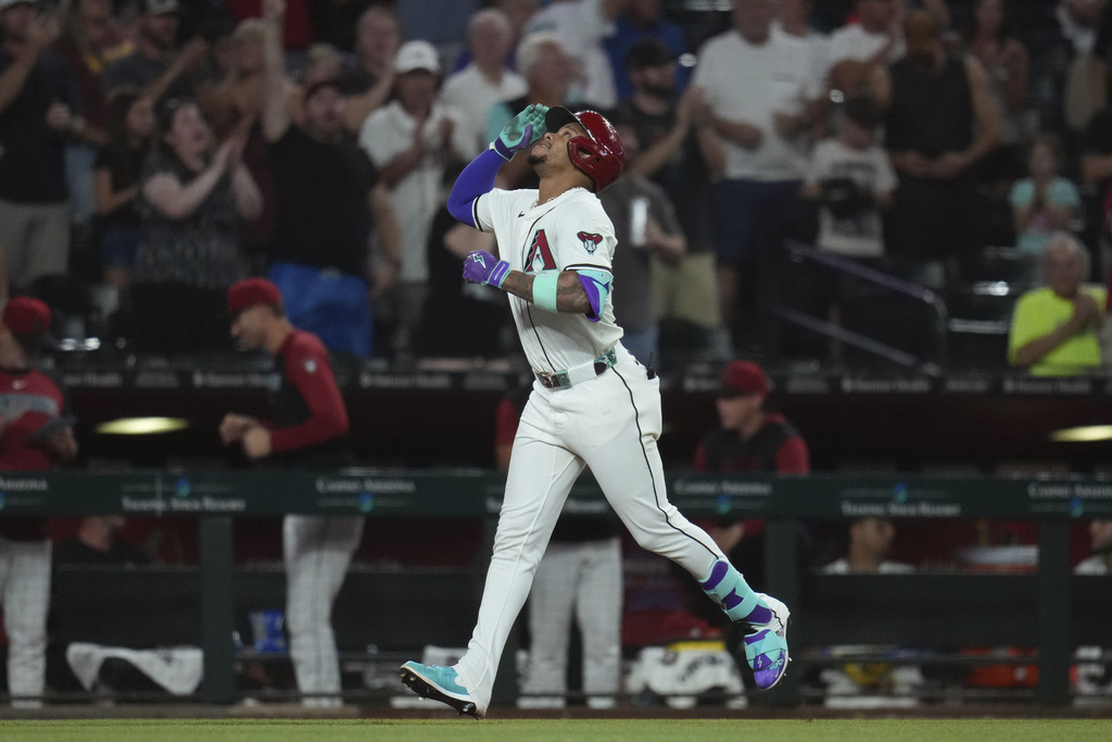 Arizona Diamondbacks' Ketel Marte rounds the bases after hitting a three-run home run against the Texas Rangers during the seventh inning of a baseball game Tuesday, Sept. 2, 2025, in Phoenix. (AP Photo/Ross D. Franklin)
