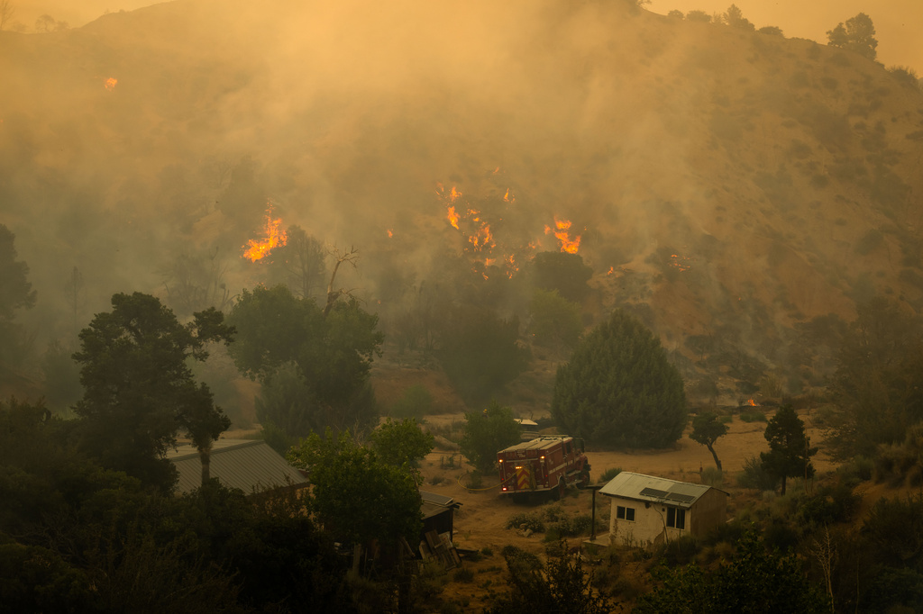 Flames rise on the Summit Fire in Llano, CA. Friday, July 10, 2026. (AP Photo/Ethan Swope)