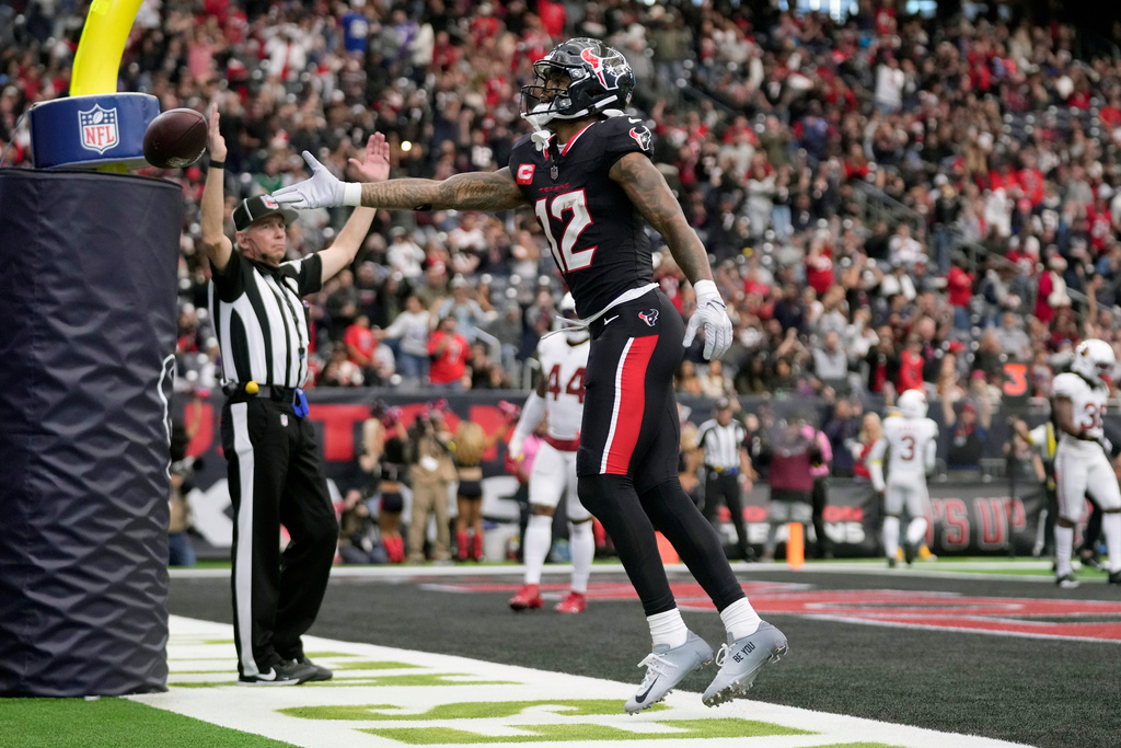 Houston Texans wide receiver Nico Collins celebrates his touchdown catch against the Arizona Cardinals during the second half of an NFL football game Sunday, Dec. 14, 2025, in Houston. (AP Photo/Eric Christian Smith)