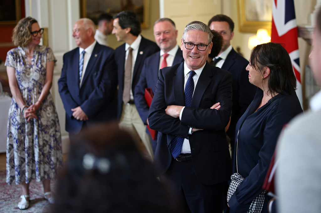 Britain's Prime Minister Keir Starmer, center right, speaks with people whose lives who are said to have been improved by the Labour Government, during a meeting inside 10 Downing Street, central London, Wednesday July 15, 2026. (Henry Nicholls/Pool Photo via AP)