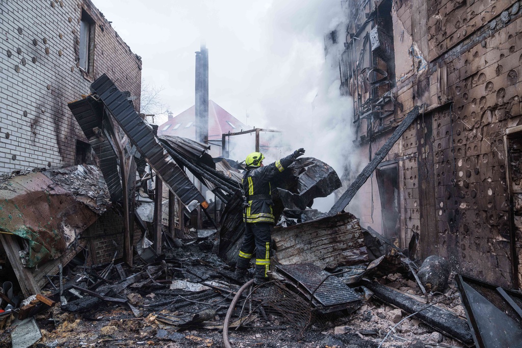 A rescue worker clears the rubble of a house destroyed after a Russian strike on Kyiv, Ukraine, on Saturday, Dec. 27, 2025. (AP Photo/Evgeniy Maloletka)