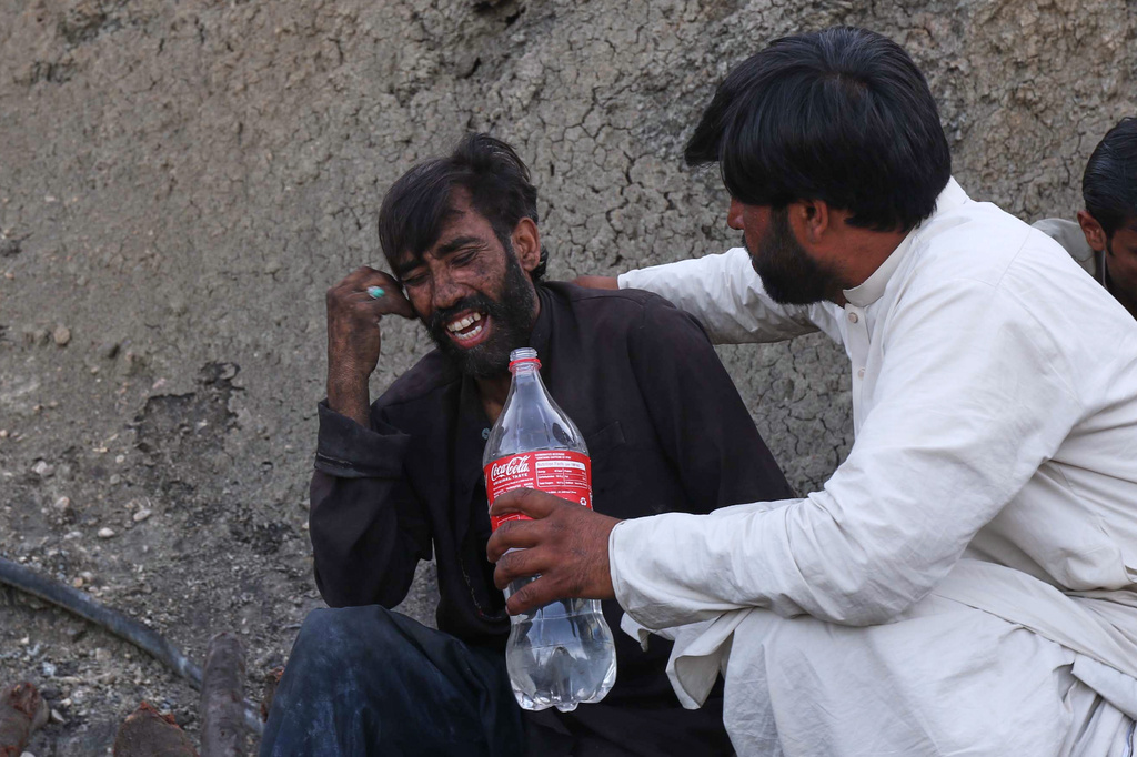A man comforts a miner mourning fellow miners killed in an explosion at a coal mine on the outskirts of Quetta, in southwest Pakistan, Thursday, July 30, 2026. (AP Photo/Fazal Tawab)