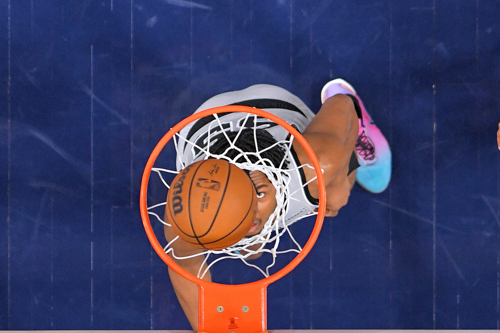 San Antonio Spurs forward Harrison Ingram watches the ball go in as the Spurs score during the second half of an NBA basketball game against the Los Angeles Clippers, Thursday, April 2, 2026, in Inglewood, Calif. (AP Photo/Mark J. Terrill)