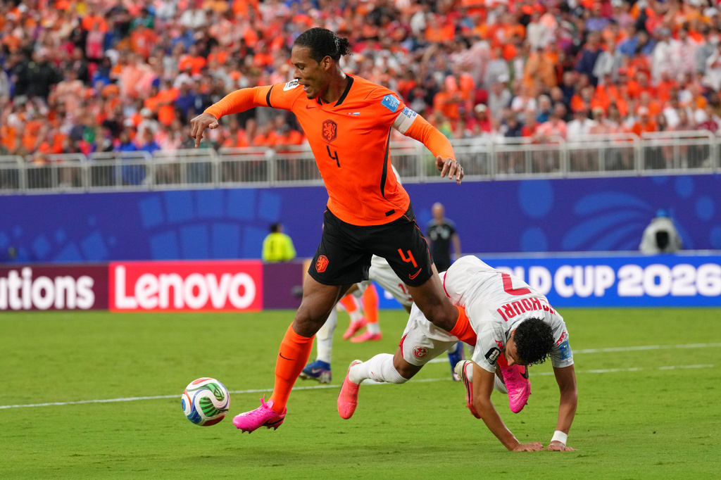 Netherlands' Virgil van Dijk, left, vies for the ball with Tunisia's Elias Achouri during the World Cup Group F soccer match between Tunisia and the Netherlands in Kansas City, Mo., Thursday, June 25, 2026. (AP Photo/Ed Zurga)