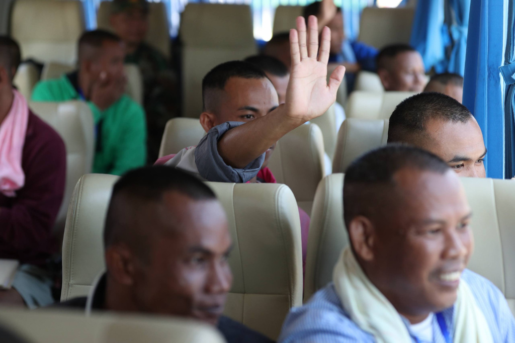 In this photo released by Agence Kampuchea Press (AKP), Cambodian soldiers sit in a van as they arrive after being captured and held by the Thai army, at Prum border gate, in Pailin province, Cambodia, Wednesday, Dec. 31, 2025. (AKP via AP)