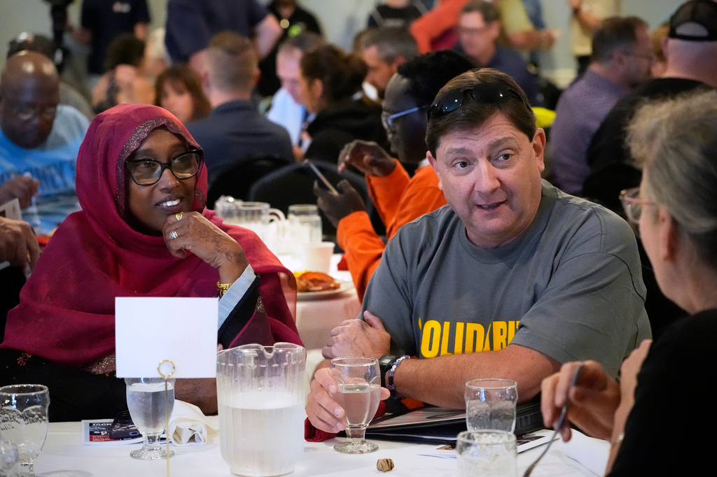 Troy Jackson, Democratic candidate for U.S. Senate, seated next to former South Portland mayor Deqa Dhalac, left, speaks with attendees at the Southern Maine Labor Council breakfast, Monday, Sept. 7, 2026, in South Portland, Maine. (AP Photo/Robert F. Bukaty)