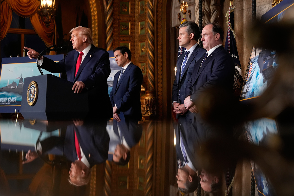 President Donald Trump speaks, with from left, Secretary of State Marco Rubio, Defense Secretary Pete Hegseth and Secretary of the Navy John Phelan,at his Mar-a-Lago club, Monday, Dec. 22, 2025, in Palm Beach, Fla. (AP Photo/Alex Brandon)