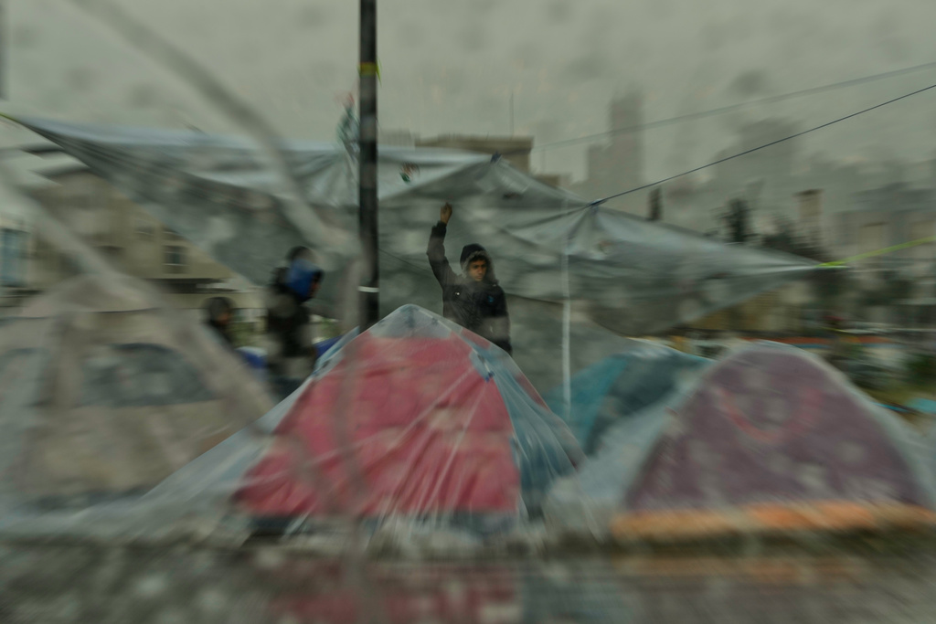 Heavy rain falls over tents sheltering people displaced by Israeli airstrikes in southern Lebanon and Dahiyeh, Beirut's southern suburbs, along the Beirut waterfront in Beirut, Lebanon, Sunday, March 15, 2026. (AP Photo/Hassan Ammar)